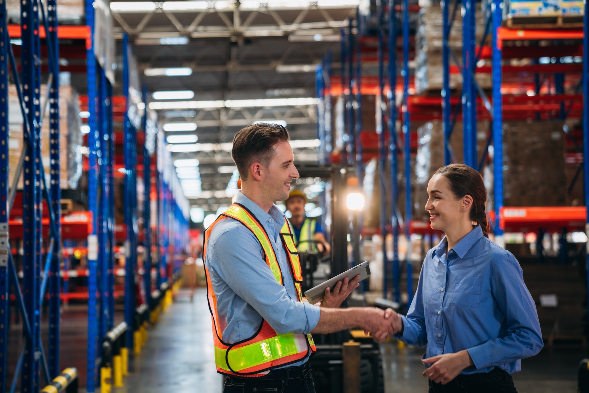 Worker in the warehouse checking the stock is on the shelves at the manufacturing. Engineer is working in the warehouse.